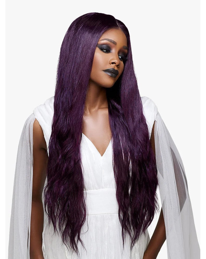 Woman models Lemelas Darcielle: a very long, deep purple wig with a middle part and loose waves.
