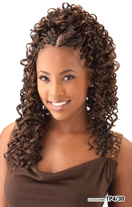 Smiling woman with shoulder-length Freetress Braid GoGo Curl in brown/auburn crochet braids and bouncy curls.